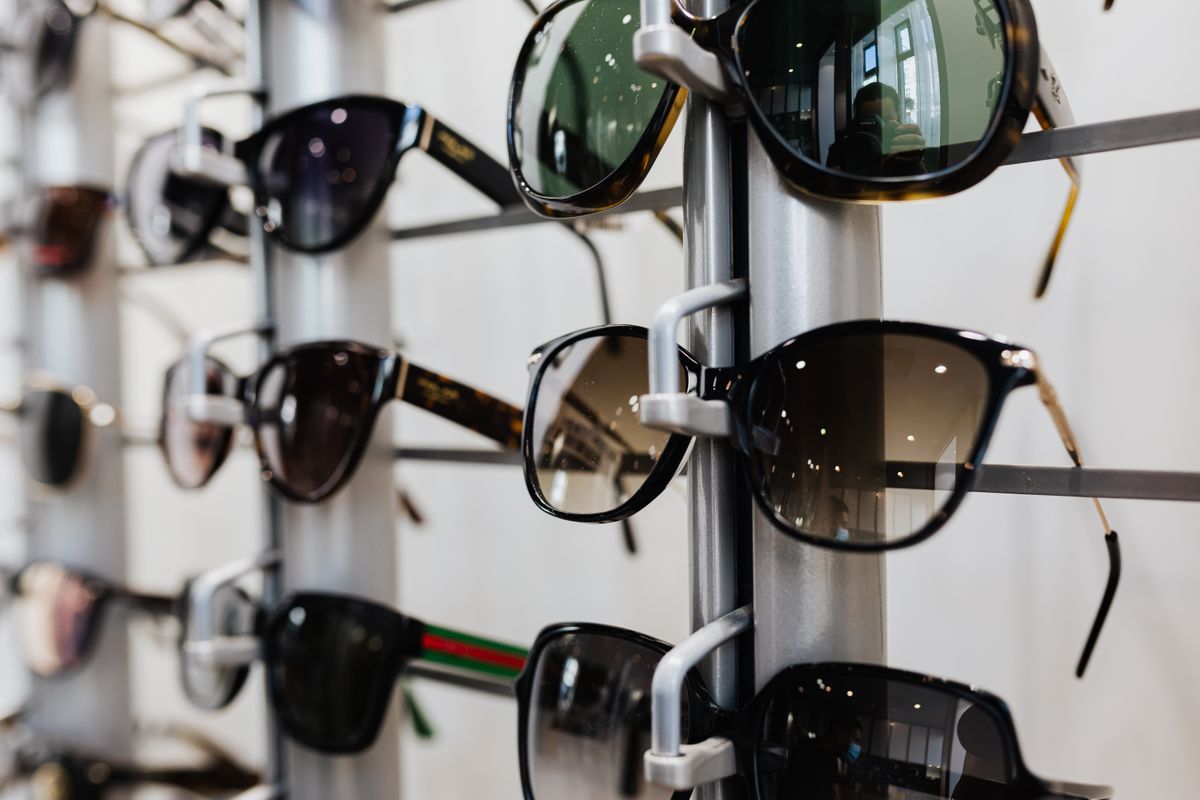 Black-framed sunglasses photographed against a plain background